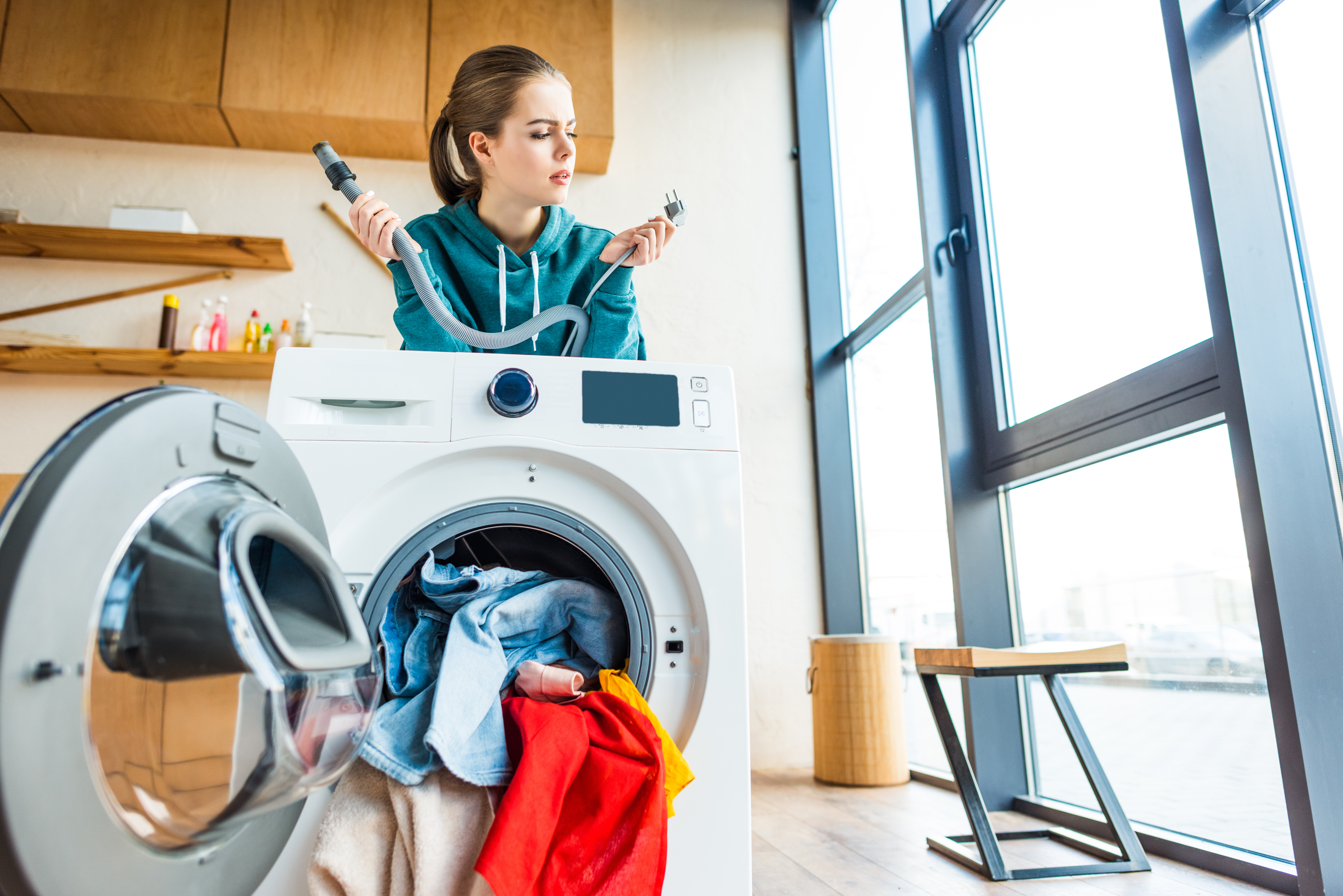 woman looking at washer hookups