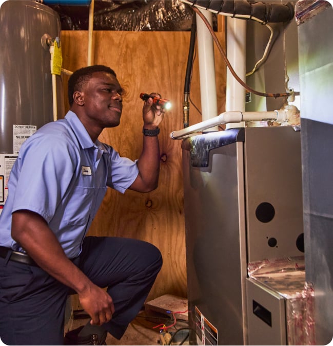 repairman fixing furnace