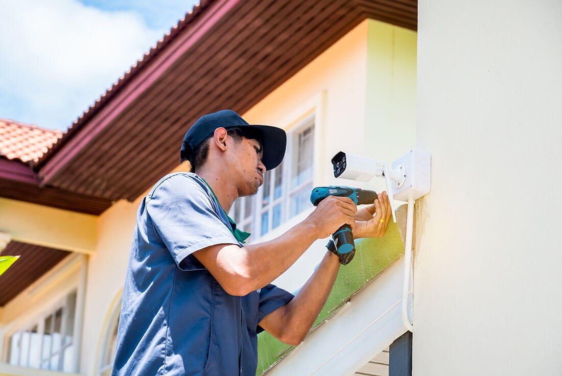 contractor installing security camera