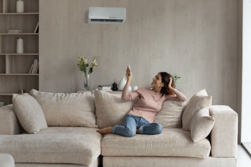 woman turning on ac