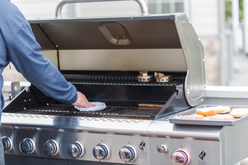 man cleaning grill