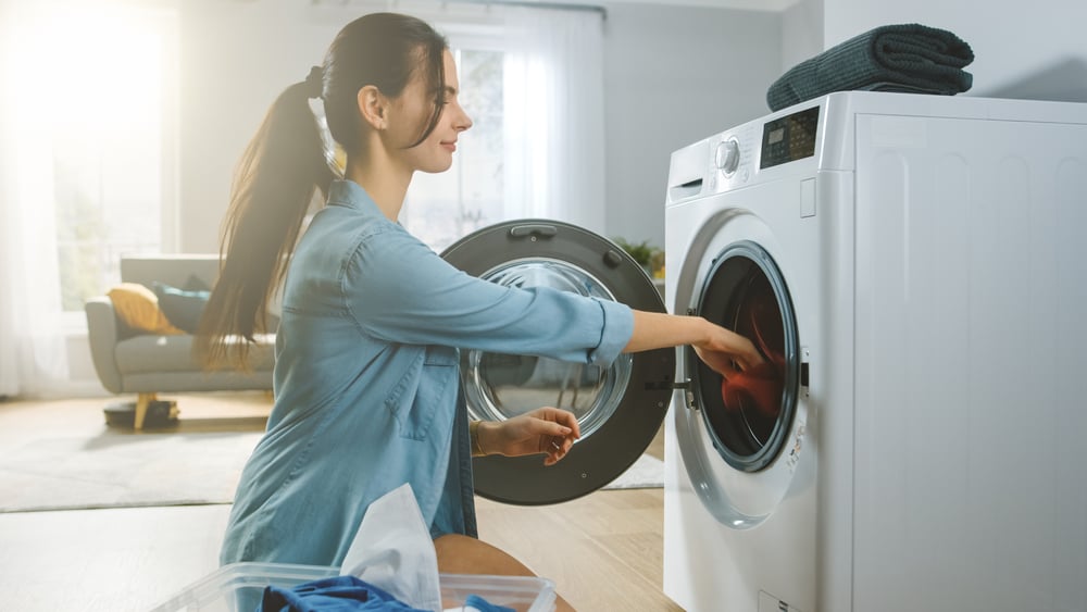 woman loading washing machine